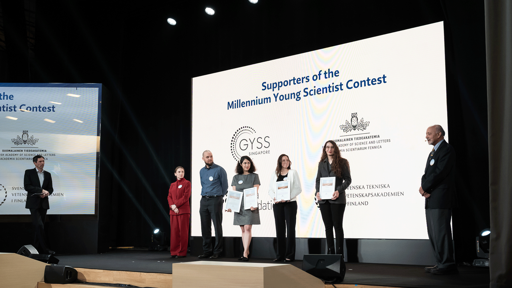 Image of 2024 Millennium Young Scientist Contest winners receiving their prizes from Professor Baliga